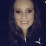 woman in a dark car taking a selfie